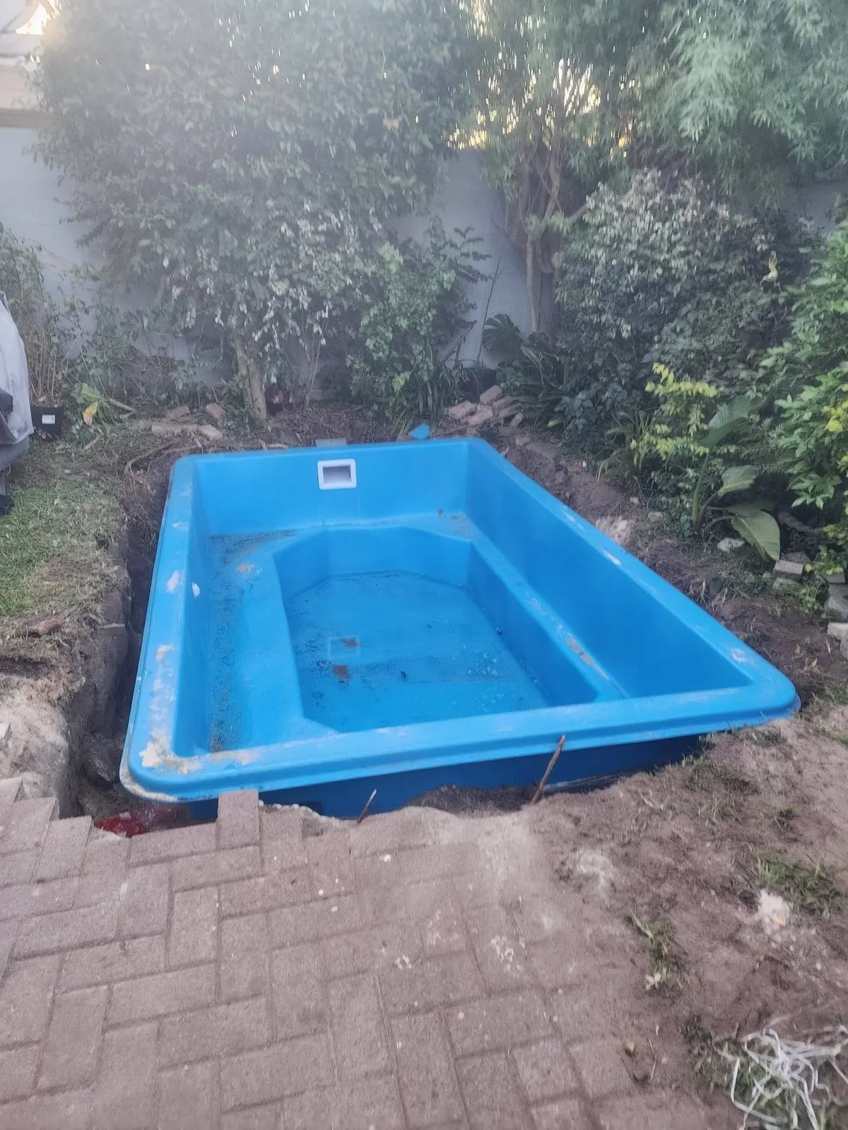 Fibreglass pool shell placed in the excavation